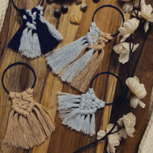 Handknotted mini macramé wall hanging bangles in earthy beige, light blue, and deep blue, each with a soft fringe