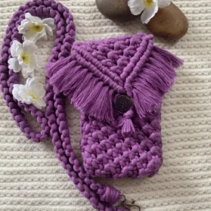 Handcrafted macramé phone slings in black and purple with fringe flap and wooden button, featuring chunky braided straps